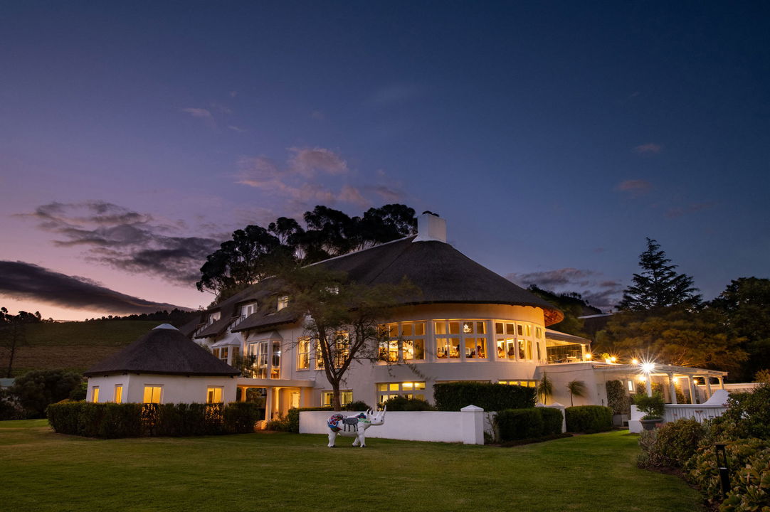 exterior dusk view of the illuminated facilities of Mont Rochelle Wine Estate