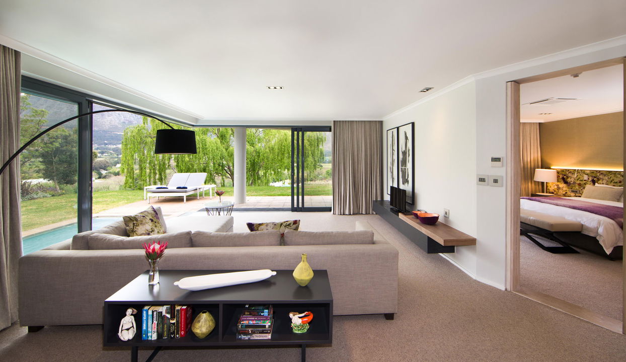 lounging area of luxury room with open patio views at Mont Rochelle Wine Estate