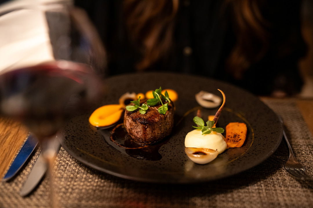 gourmet steak served on black plate at Mont Rochelle luxury Hotel in Franshoek