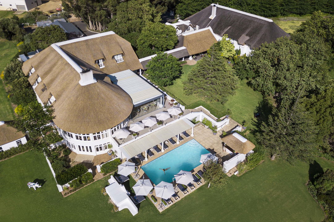 ariel view of hotel and pool from above in cape winelands of  Virgin Unlimited Mont Rochelle Luxury Hotel in Franshoek