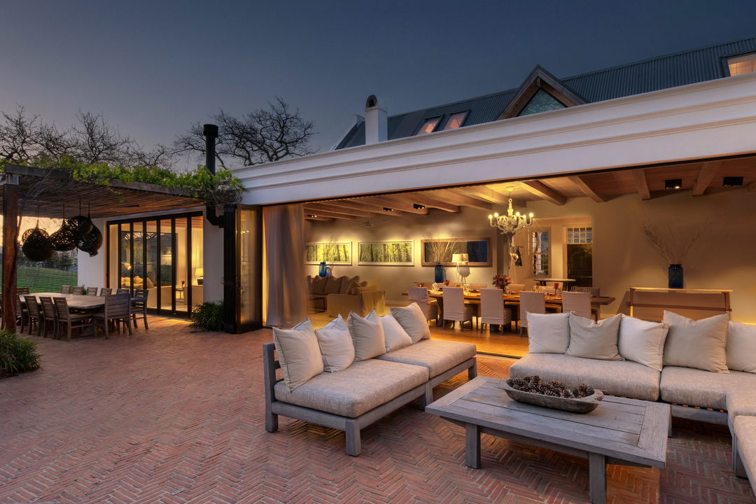 evening view of illuminated lounge and patio at Mont Rochelle Luxury Hotel in Franshoek