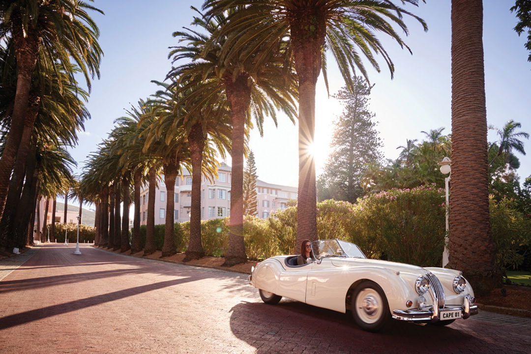 classic car driven down arrival lane of Mount Nelson hotel Cape Town