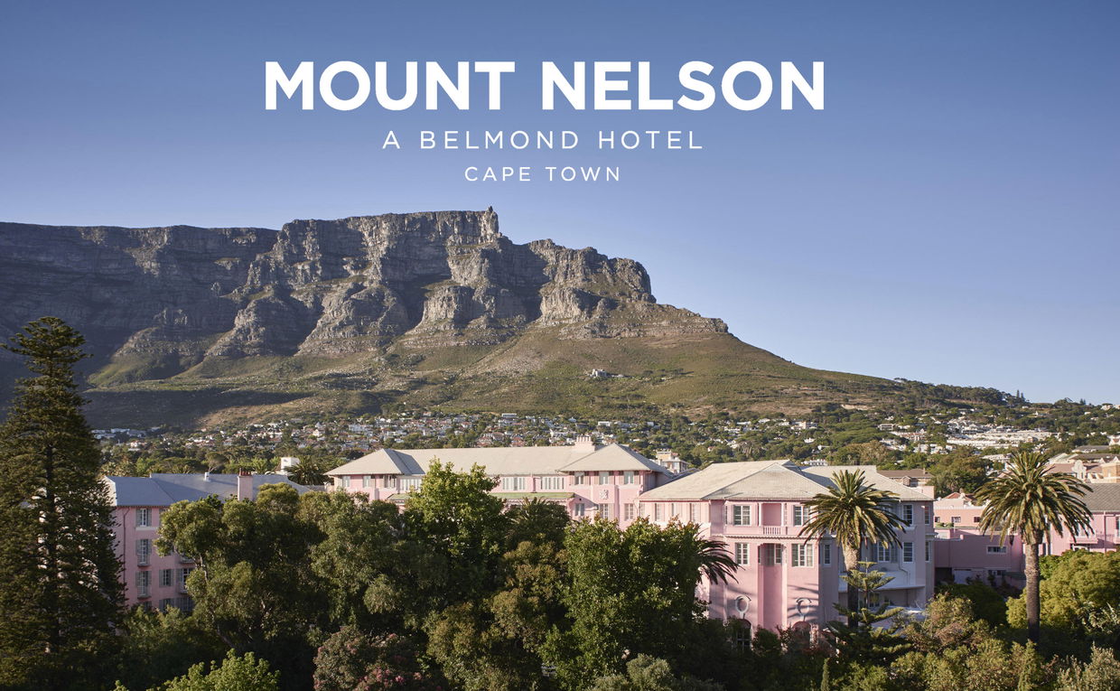 exterior view of the Mount Nelson Hotel Cape Town underneath table mountain in background with logo overlay exterior view of the Mount Nelson Hotel Cape Town underneath table mountain in background with logo overlay