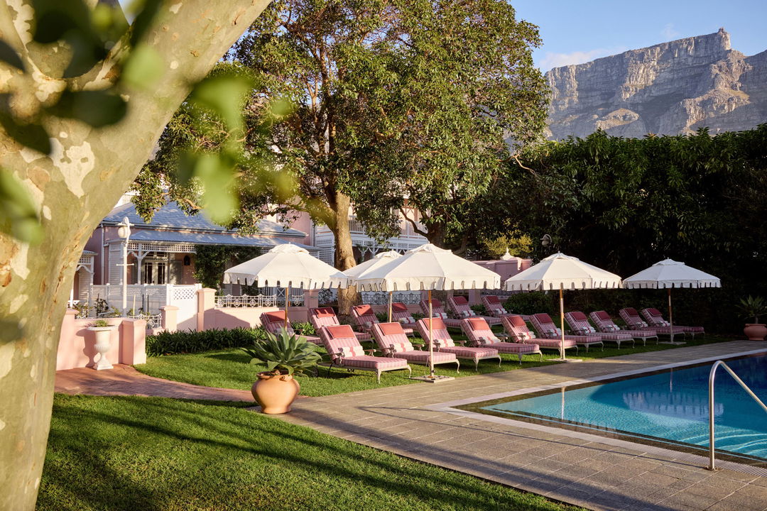 loungers under umbrellas at the pool of Mount Nelson Hotel Cape Town