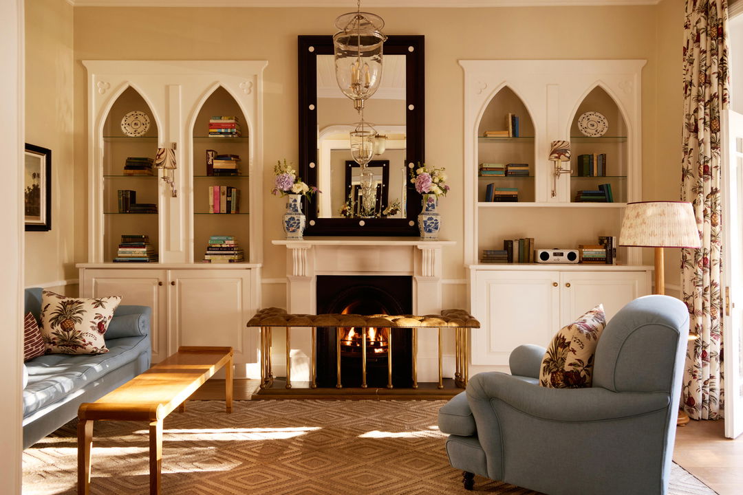 loungers by fireplace in luxury room of mount nelson cape town