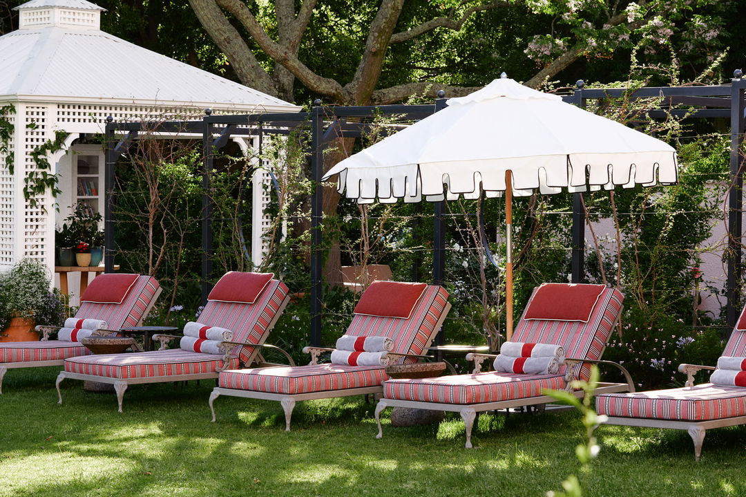 loungers under umbrella on terrace of mount nelson cape town