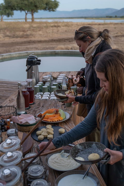guests having breakfast by Nyamatusi Camps Mana Pools Zimbabwe 
