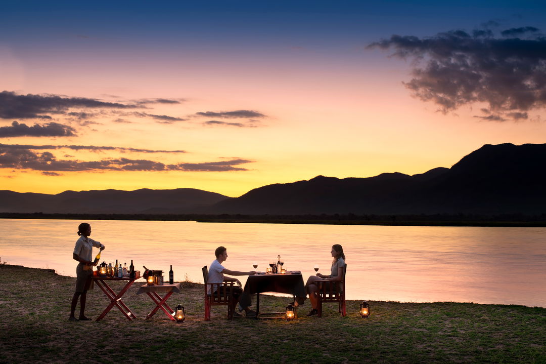 bush dinner by river for guests of Nyamatusi Camps Mana Pools Zimbabwe 