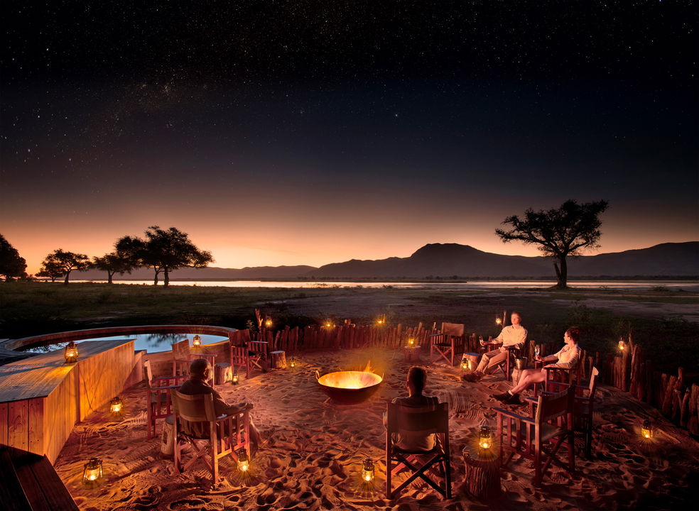 fireplace boma with guests at night by Nyamatusi Camps Mana Pools Zimbabwe 