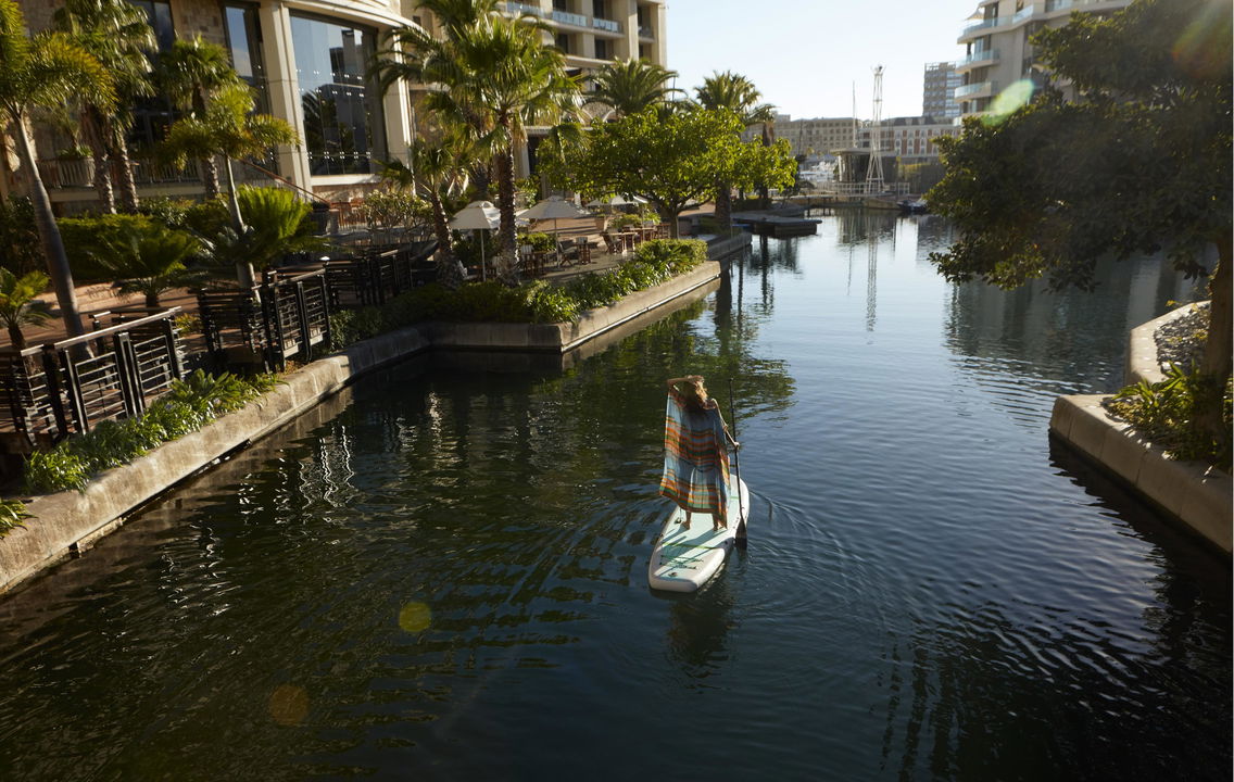 lady guest on paddleboard in canal at One&Only Resort Waterfront Cape Town
