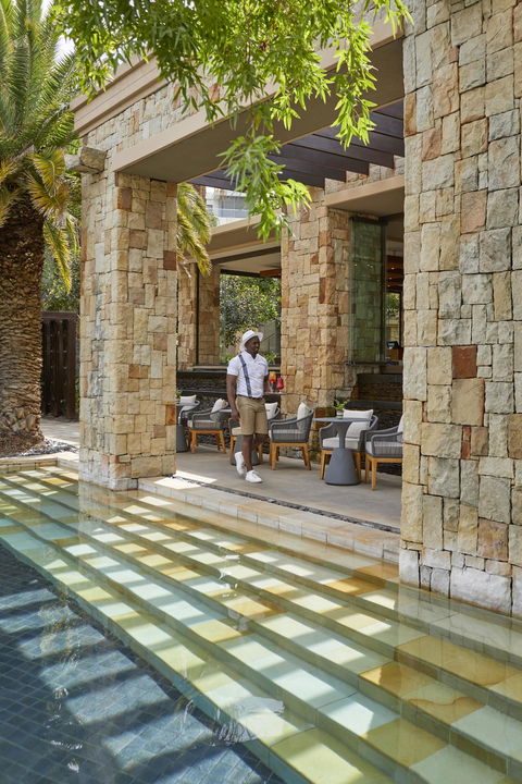 guest walking near canals in front of room at One&Only Cape Town