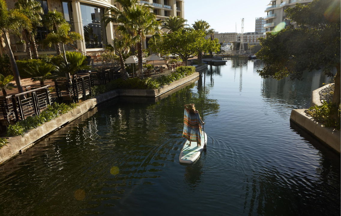 lady guest on paddleboard in canal at One&Only Resort Waterfront Cape Town