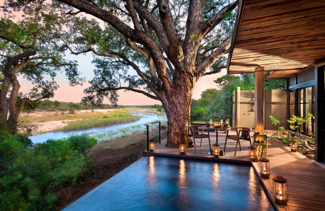 view of river beyond from pool deck at &Beyond Tengile River Lodge Sabi Sands
