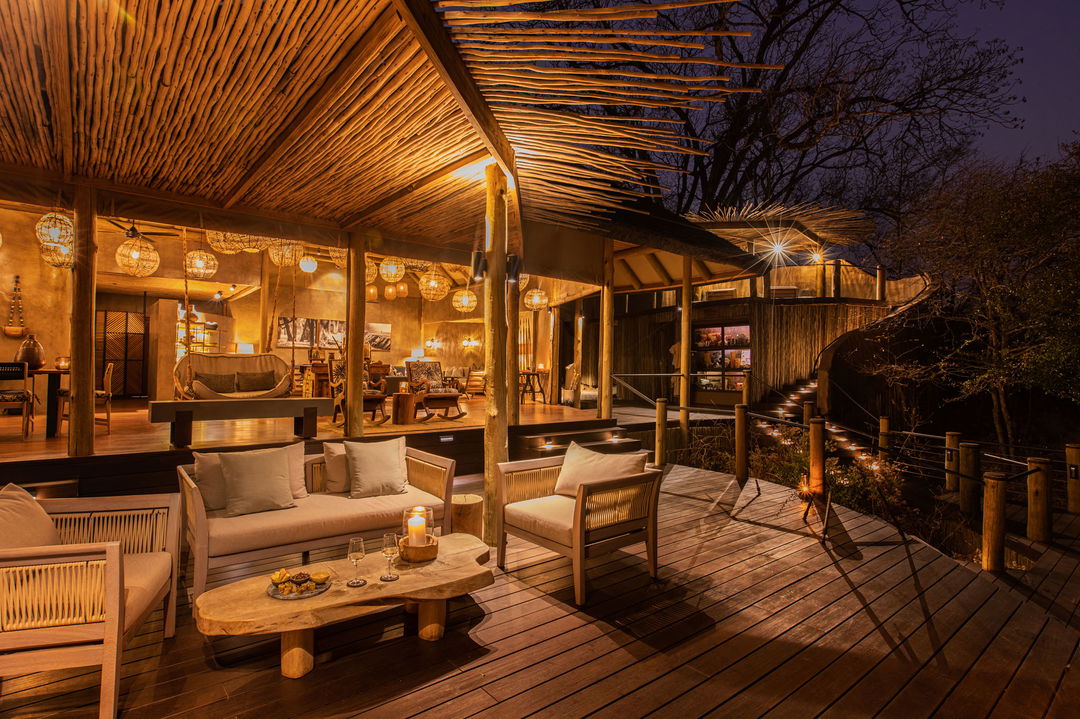 night view of the main lounge on deck of Puku Ridge Camp Zambia Luangwa Plains