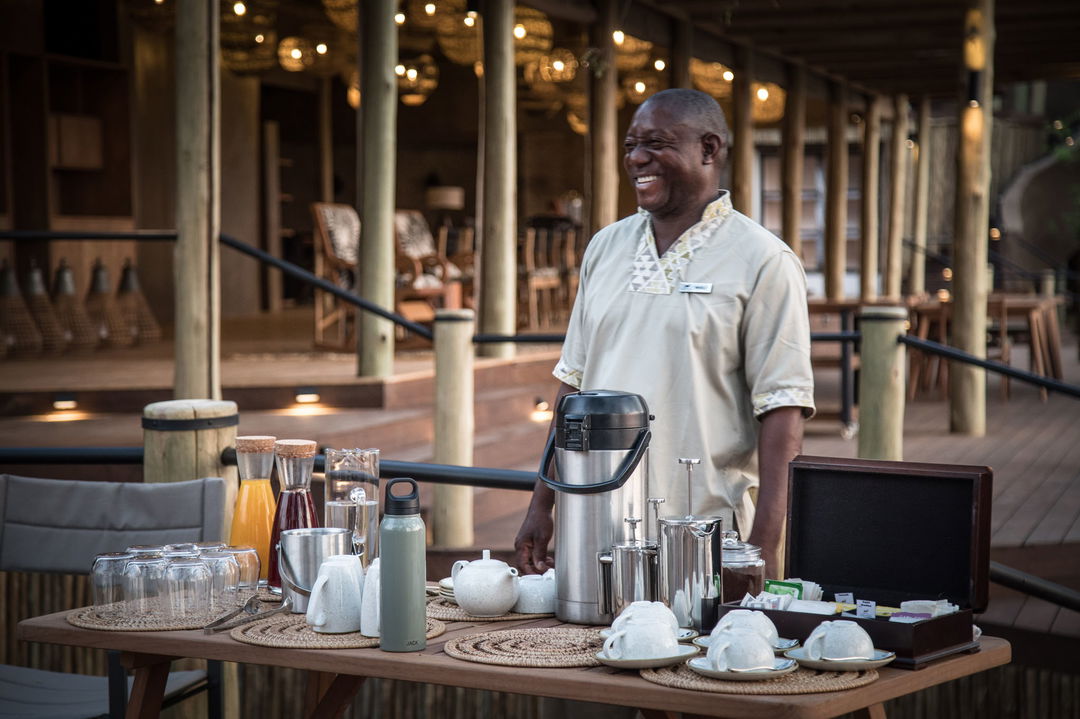 staff on deck with coffee prepared for guests at Puku Ridge Camp Zambia