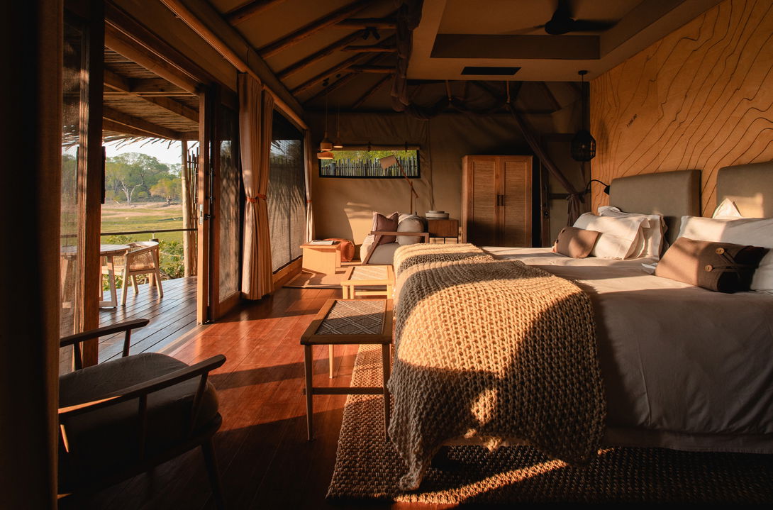 sunlit view of bedroom in morning in a suite of Puku Ridge Camp Zambia Luangwa Plains