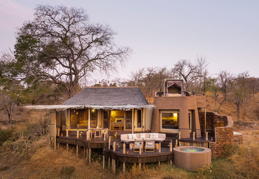 exterior view of villa at sunset by Puku Ridge Camp Zambia Luangwa Plains