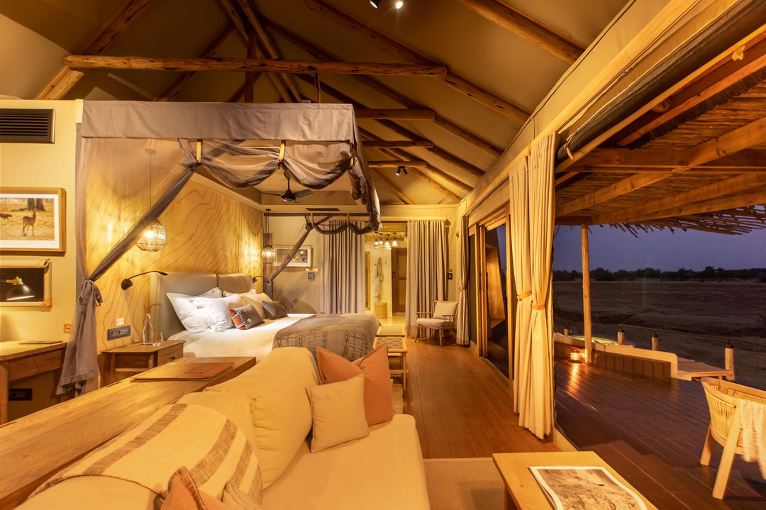 night view of an illuminated bedroom of the villa of Puku Ridge Camp Zambia Luangwa Plains