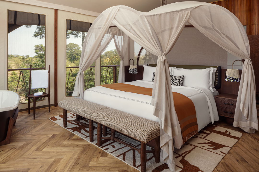 four pot bed in bedroom of a suyite by ritz carlton masai mara