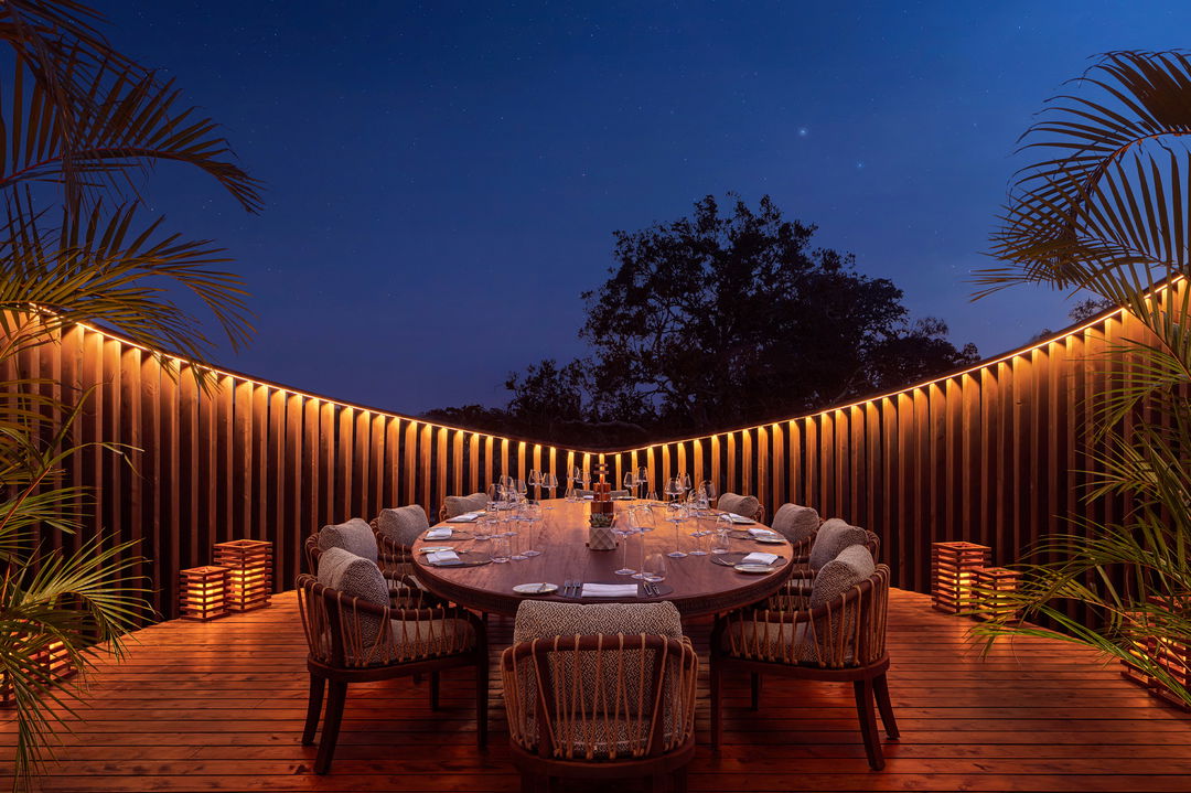 fireplace at night with tables set for supper at ritz carlton masai mara
