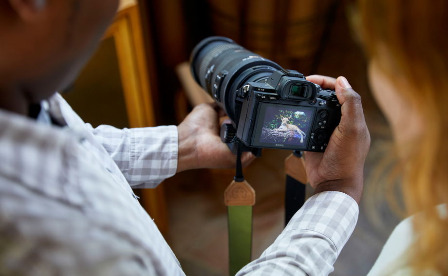 guide looking at picture taken by guest of a leopard by Lion Sands Game Reserve guide looking at picture taken by guest of a leopard by Lion Sands Game Reserve