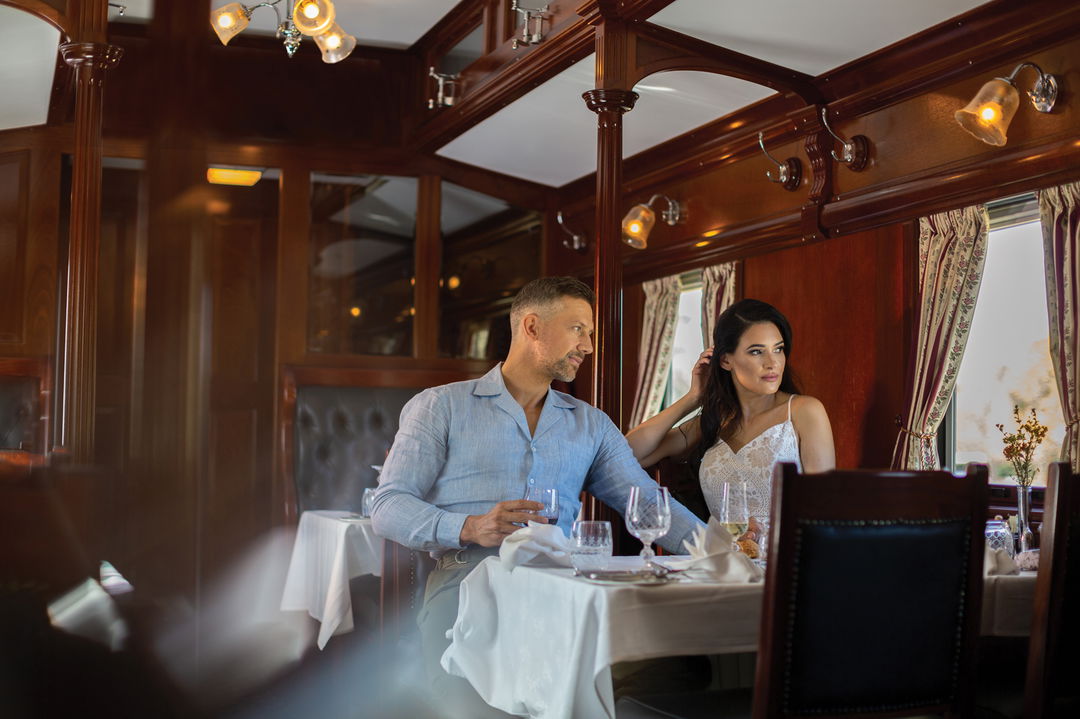 couple having dinner in the dining cart of Rovos Rail Luxury Trains