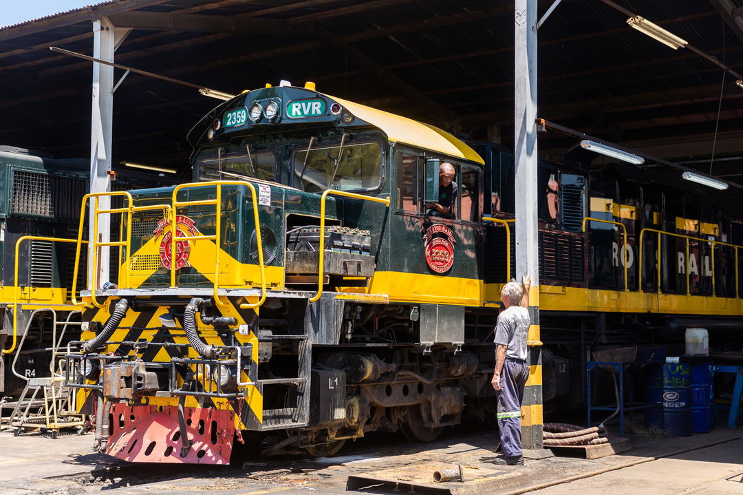 mechanic standing next to train locomotive at the station of Rovos rail luxury train safaris