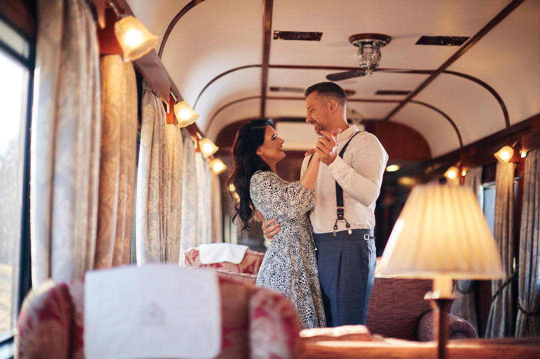 couple dancing in the lounge area of Rovos Rail Luxury Trains
