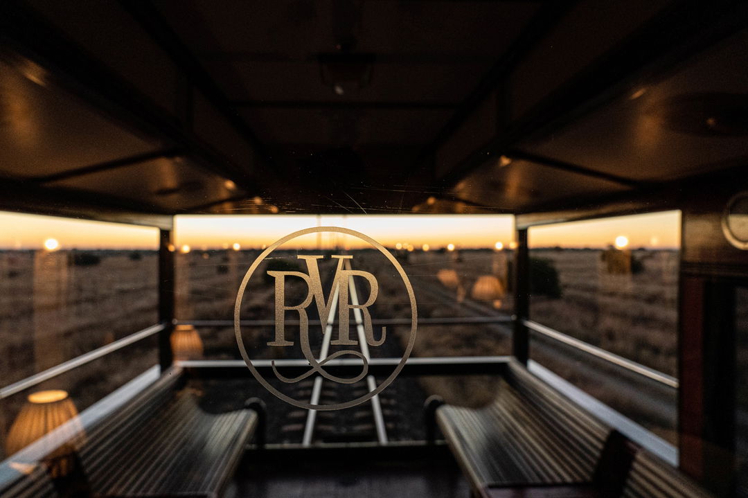 glass separation with Rovos rail logo embossed at back of observation cart at Rovos rail luxury train safaris
