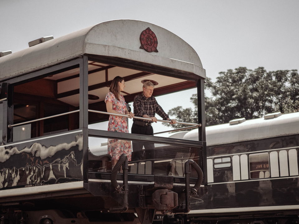 guests standing on observation cart of train at Rovos rail luxury train safaris