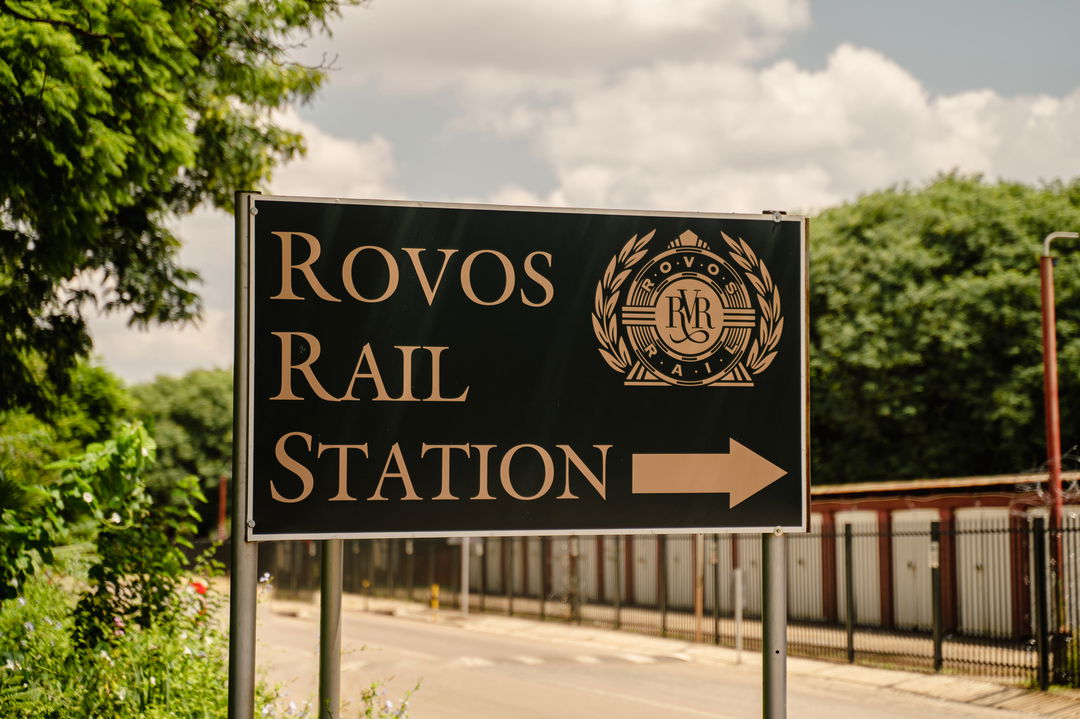 sign of Rovos rail station next to road at Rovos rail luxury train safaris