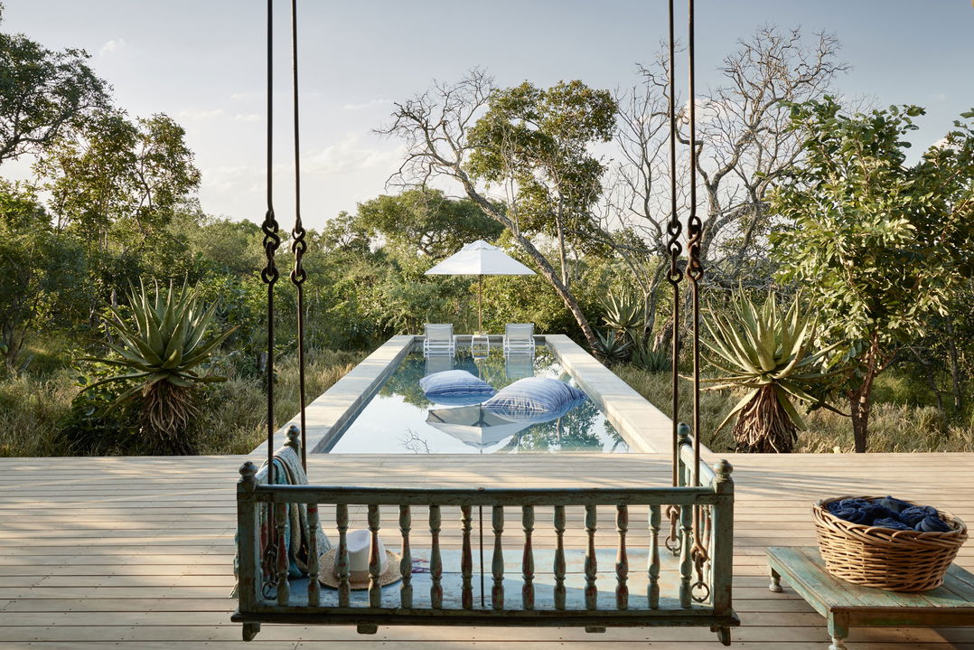 bench by pool of main lodge farmhouse royal malewane