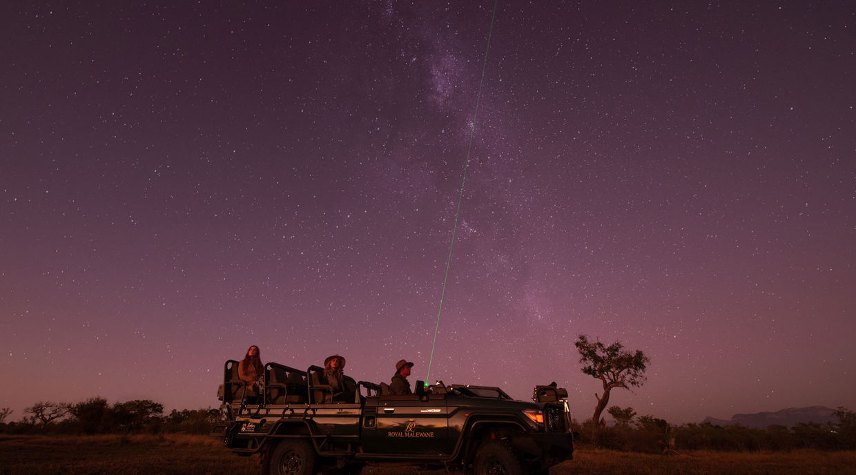 guest in safari vehicle at night on star gazing safari by Royal Malewane Lodges