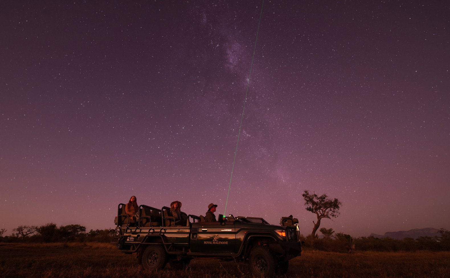 guest in safari vehicle at night on star gazing safari by Royal Malewane Lodges