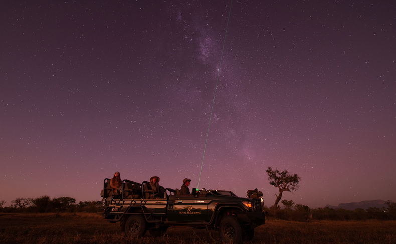 guest in safari vehicle at night on star gazing safari by Royal Malewane Lodges guest in safari vehicle at night on star gazing safari by Royal Malewane Lodges