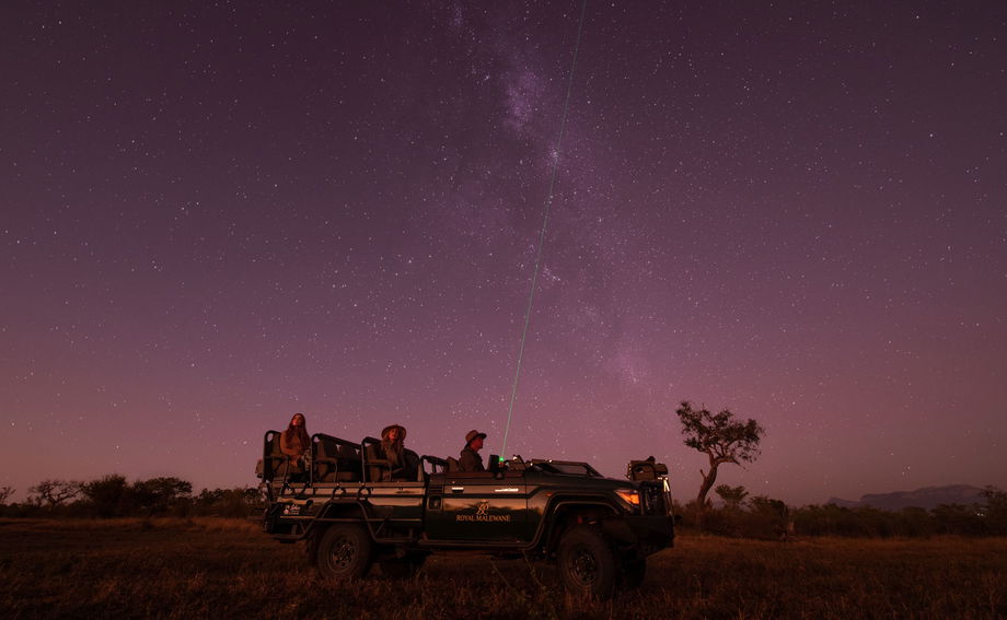 guest in safari vehicle at night on star gazing safari by Royal Malewane Lodges