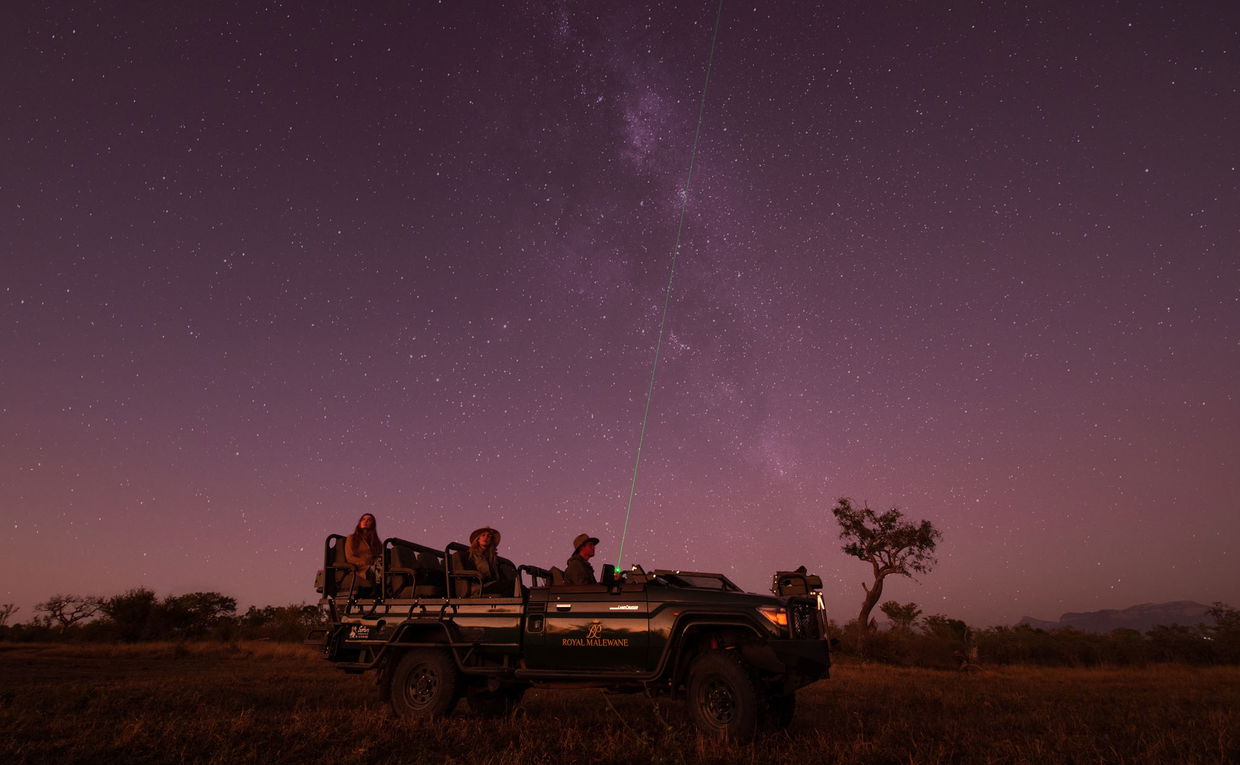 guest in safari vehicle at night on star gazing safari by Royal Malewane Lodges