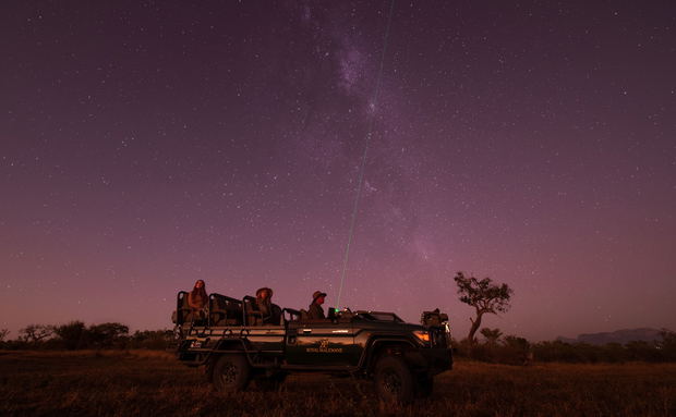 guest in safari vehicle at night on star gazing safari by Royal Malewane Lodges guest in safari vehicle at night on star gazing safari by Royal Malewane Lodges
