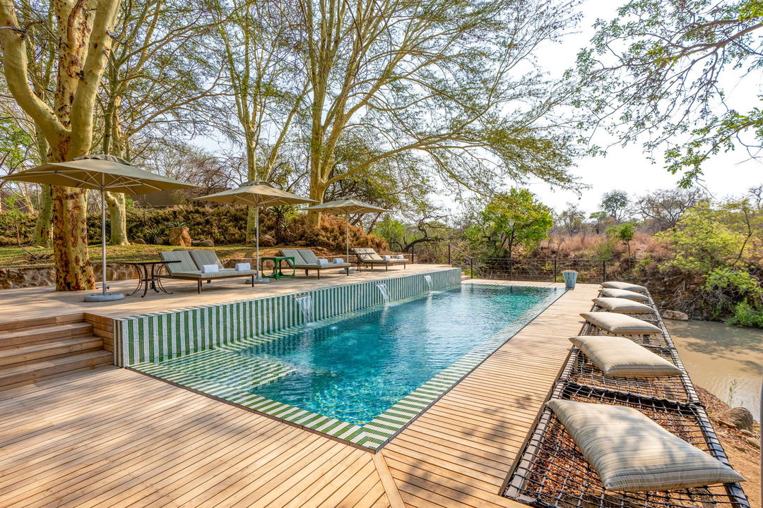 view of the main lodge pool at royal malewane waterside lodge