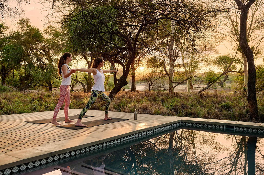 guests doing yoga on desk at royal malewane waterside lodge