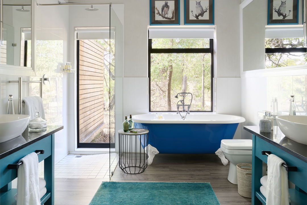 Royal Malewane Waterside House Bathroom with blue bathtub and open windows