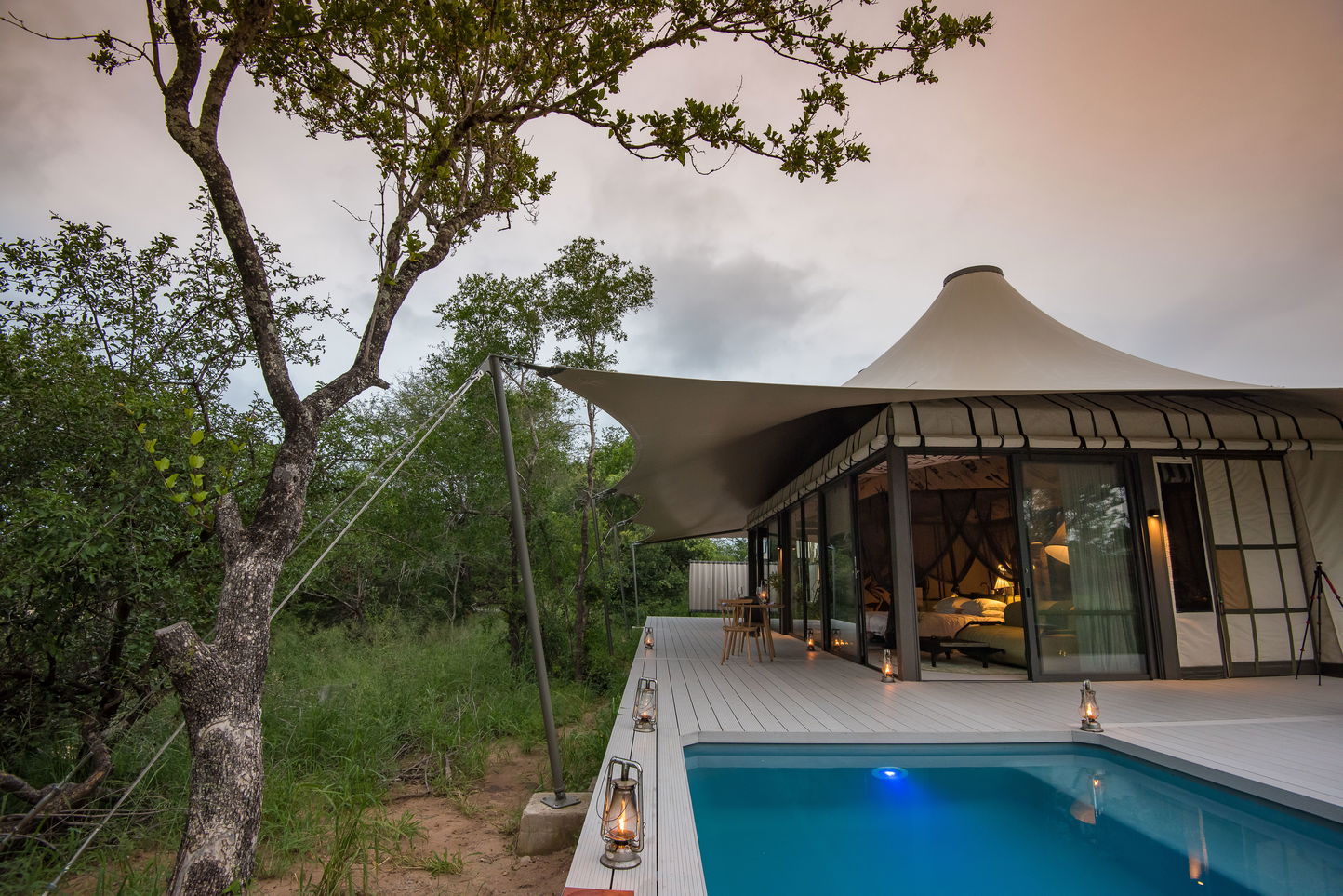 Tented room with deck and pool in bush by Saseka Tented Camp at Thornybush