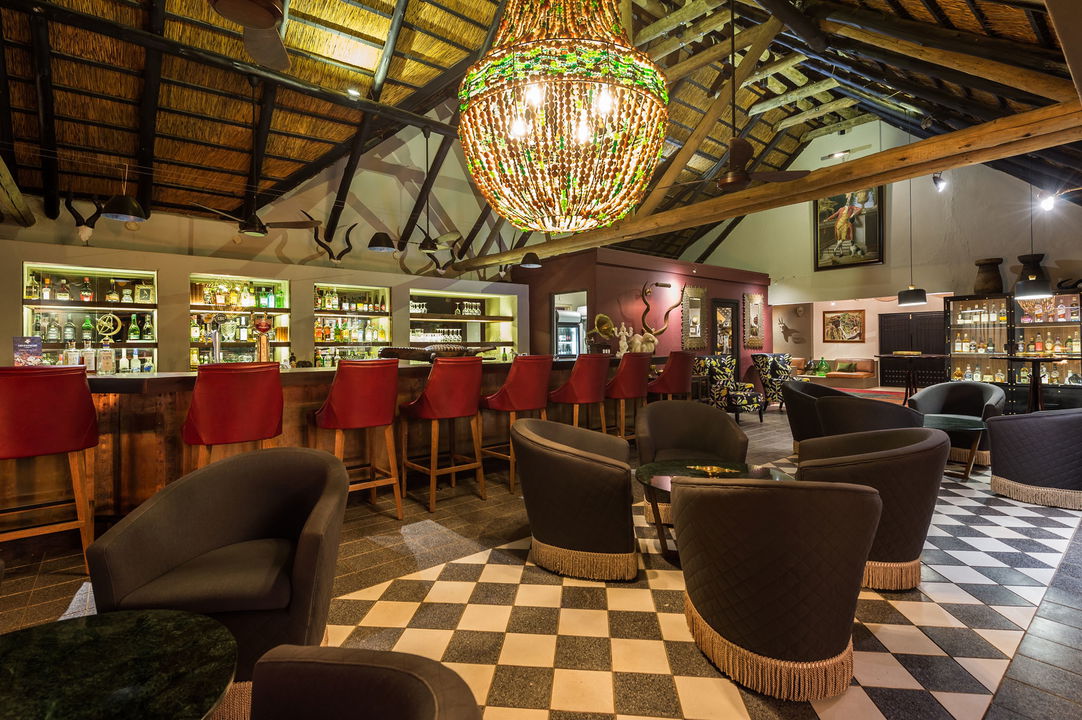 bar area of sabi sabi bush lodge with red chairs