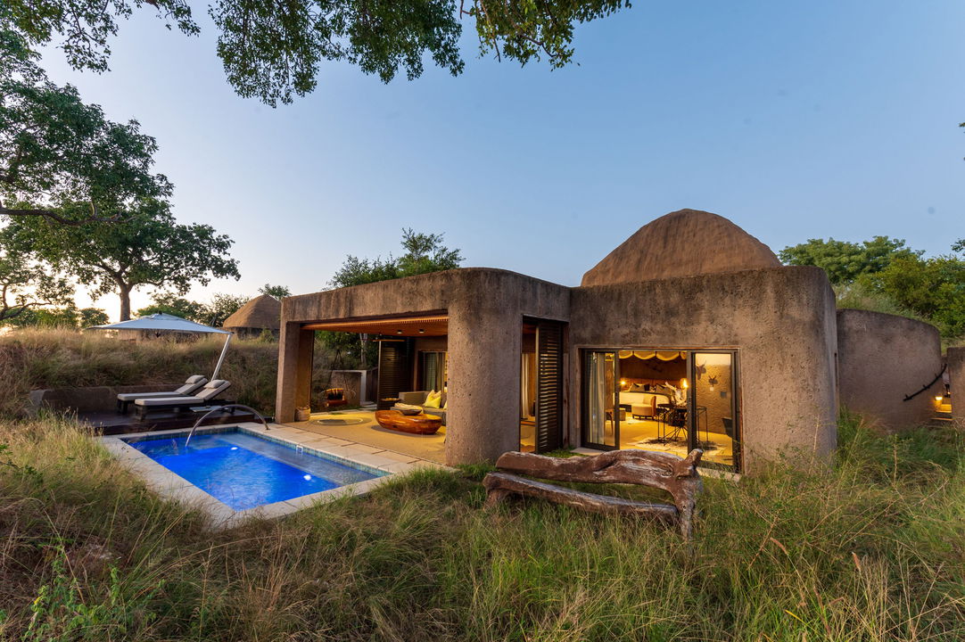 exterior view of sabi sabi earth lodge at sunset showing pool by suite