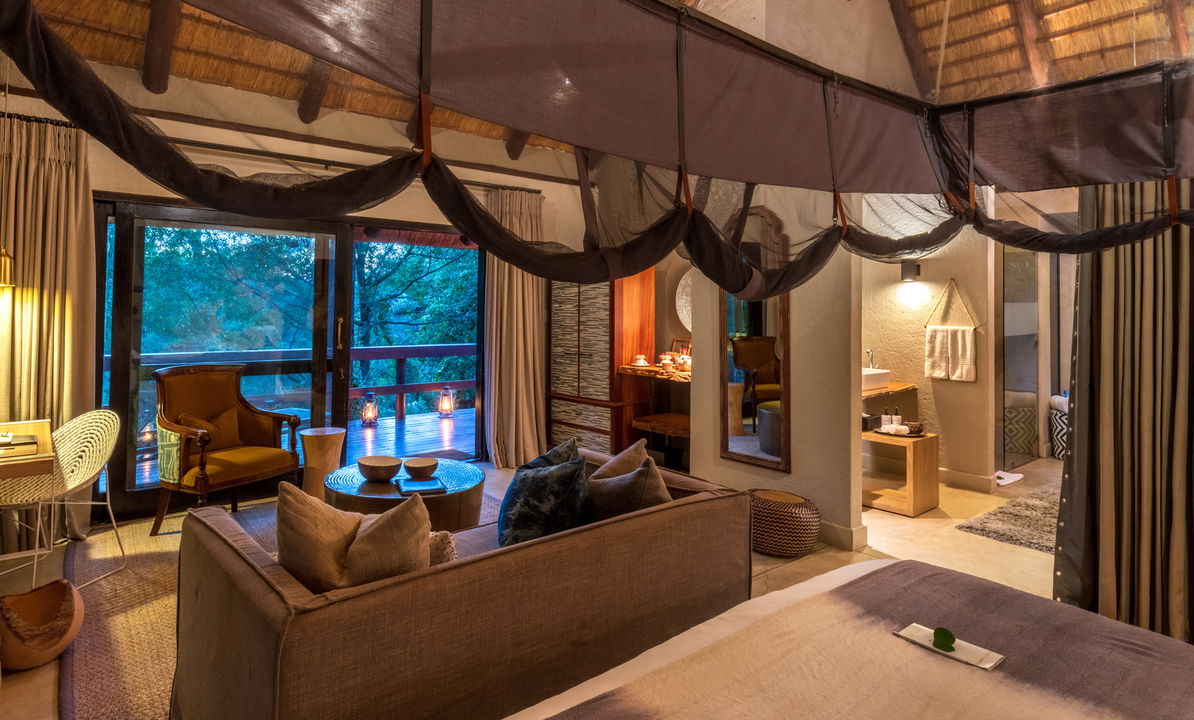 interior view of luxury suite at night by little bush camp sabi sabi