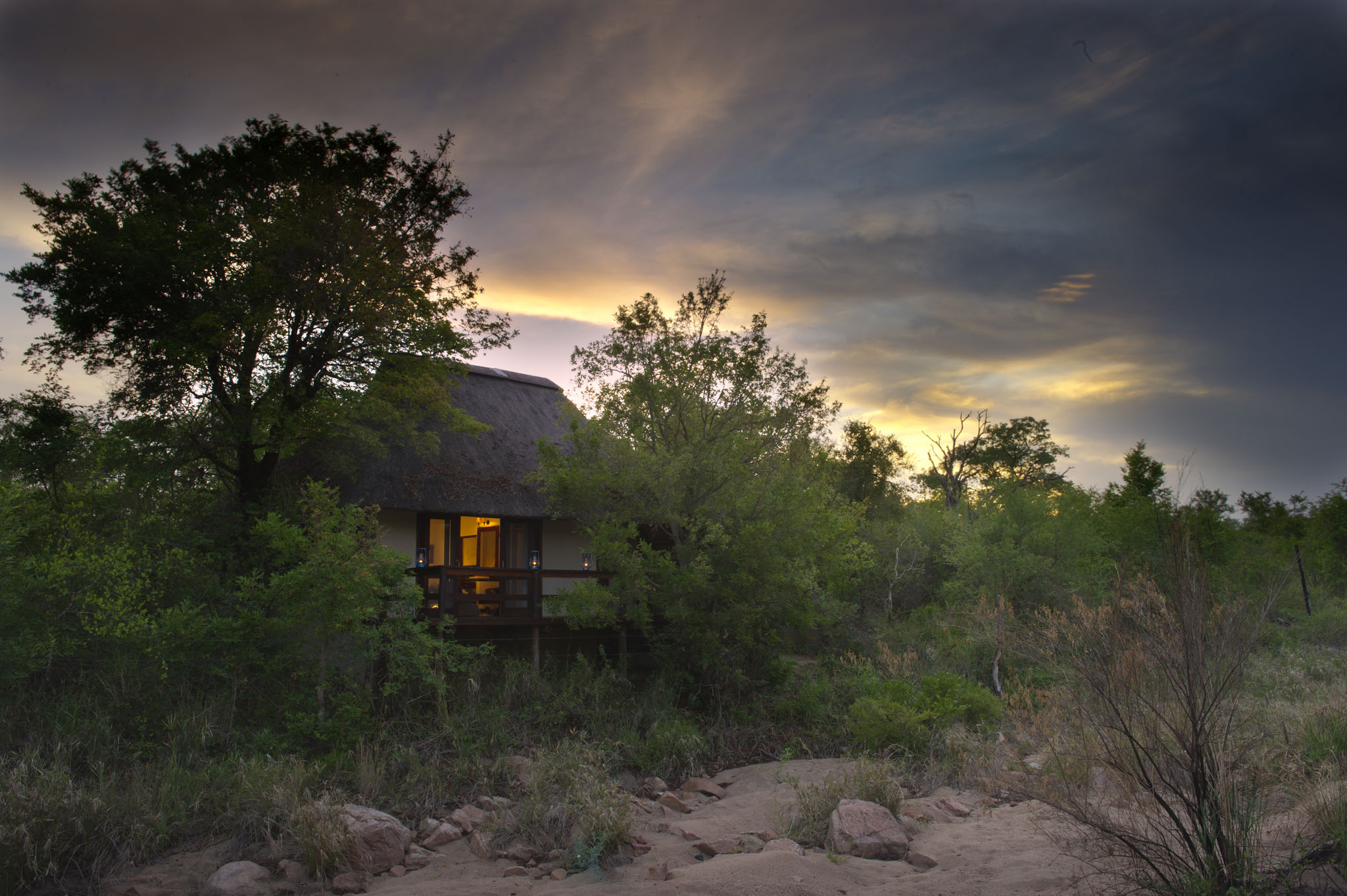 evening view of suite from riverbed at little bush camp sabi sabi