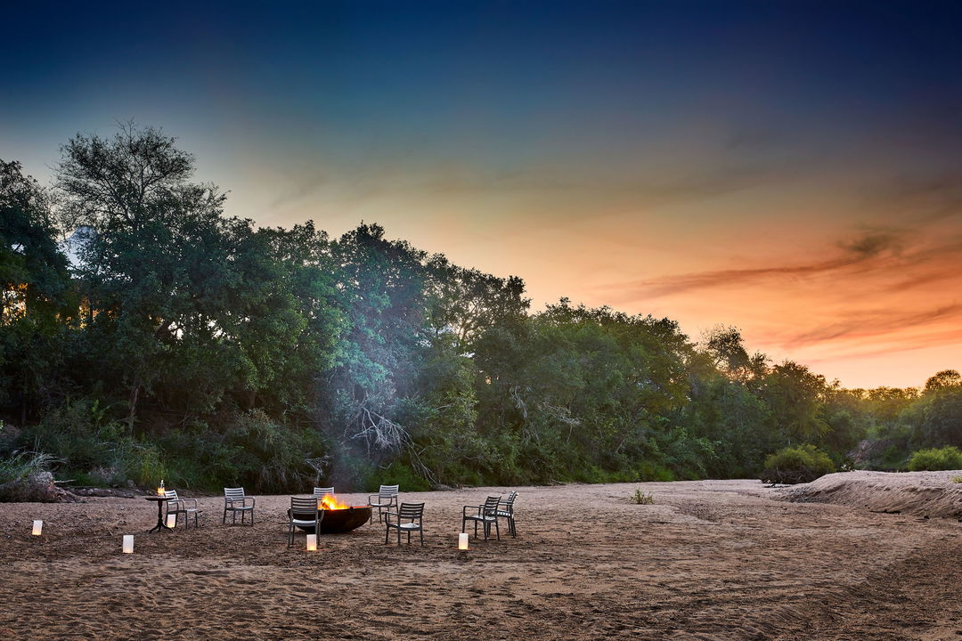 dry riverbed with fireplace and chairs ready for sunset drinks at Saseka tented camp Thornybush
