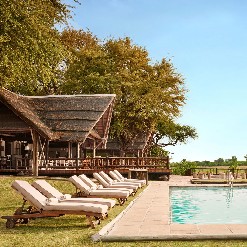 deck chairs arranged by pool at kwai river lodge Botswana