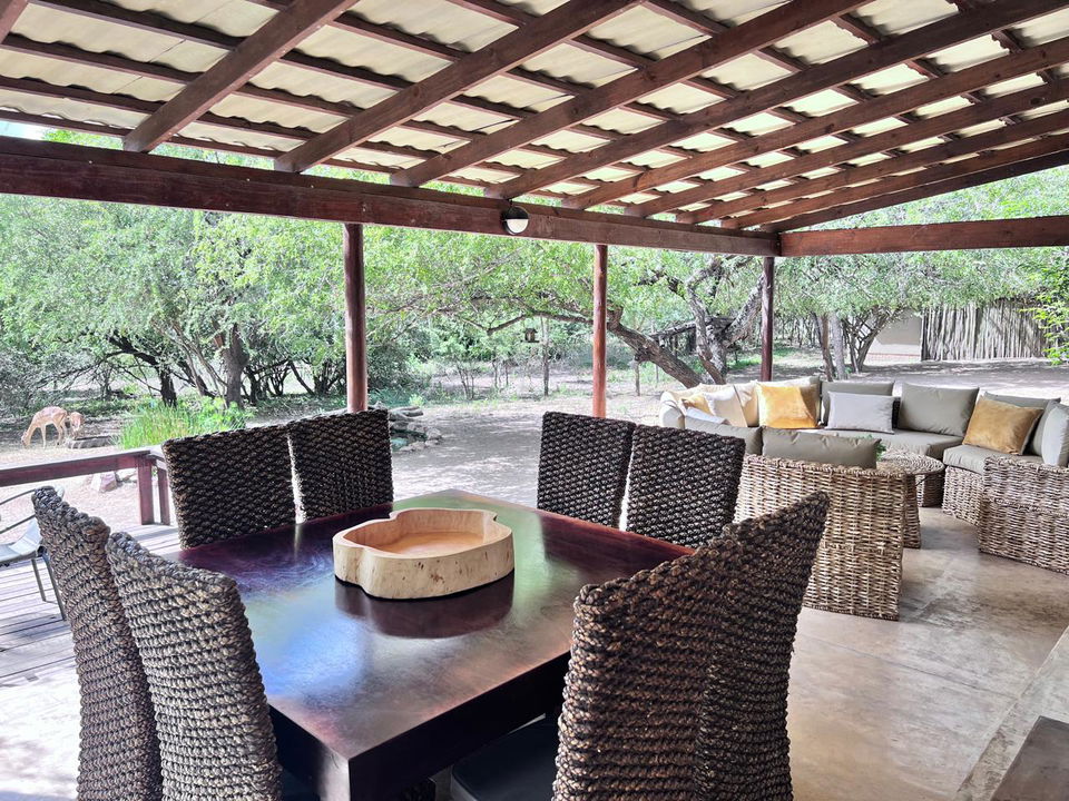 dining table on patio at secrets VIP luxury lodge