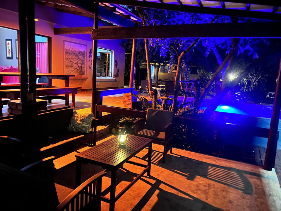 deck at night with pool illuminated in background at secrets VIP lodge